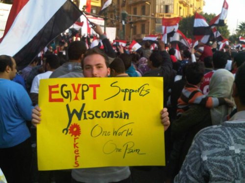 An Egyptian protestor holds up a sign reading Egypt supports Wisconsin